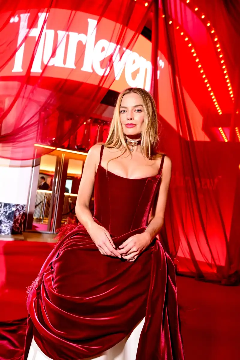 Margot Robbie flashes her toned midriff in a black military-style jacket and low rise jeans as she hits the red carpet at 1536 West End opening - 2