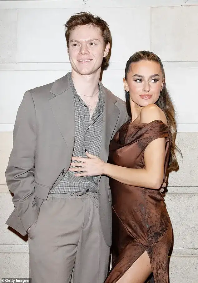Amber Davies stuns in a vibrant red feathered dress as she cosies up to boyfriend Ben Joyce while leading the stars at the WhatsOnStage awards - 2