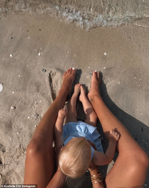 Arabella Chi poses in a bikini with baby daughter Gigi as she shares carefree snaps from Dubai while expats rush to flee the Gulf state amid 'rising panic' - 1