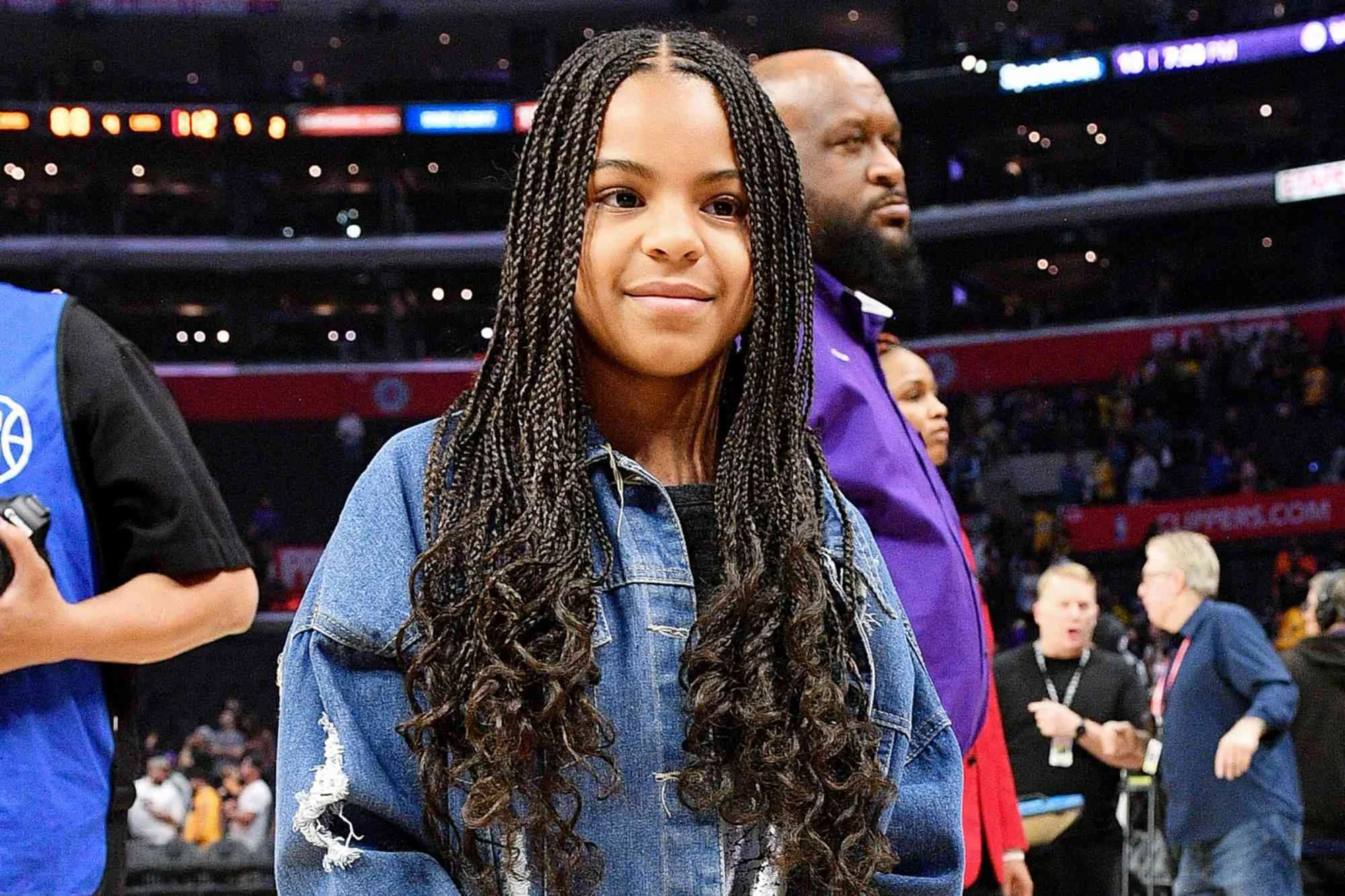 Blue Ivy, 14, recreates her annual jumping picture on the field as she attends the Super Bowl with her dad and rarely-seen sister Rumi, eight - 1